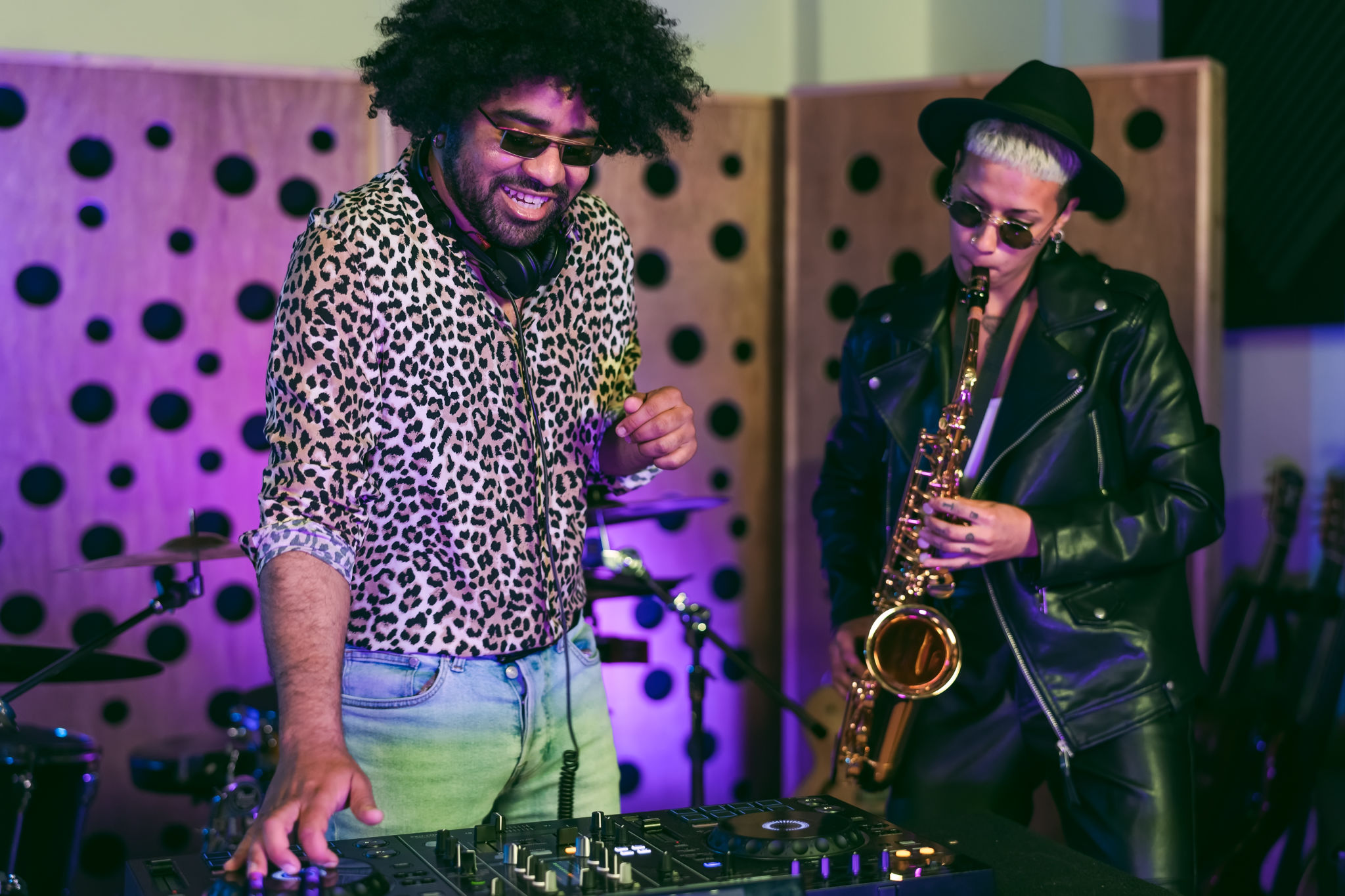 Young happy people playing music with dj mixer and saxophone in house studio - Youth musician entertainment concept Young happy people playing music with dj mixer and saxophone in house studio - Youth musician entertainment concept