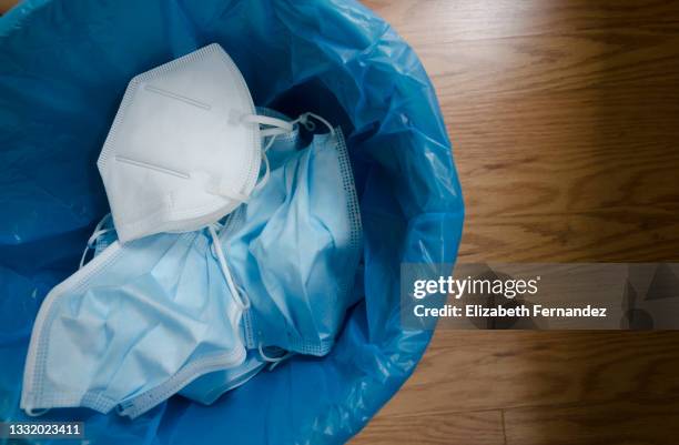 recycling face masks: used hygienic masks in the trash bin. - mask imagens e fotografias de stock
