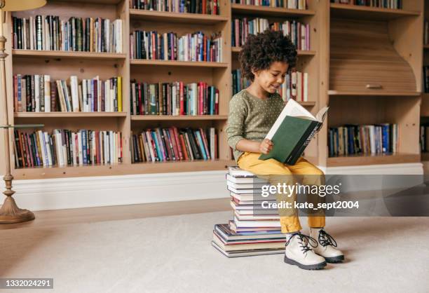 smiling preschooler holding a book - holding book stock pictures, royalty-free photos & images