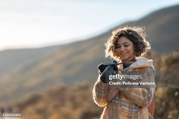 young tourist camera mountain winter - camera girls stock pictures, royalty-free photos & images