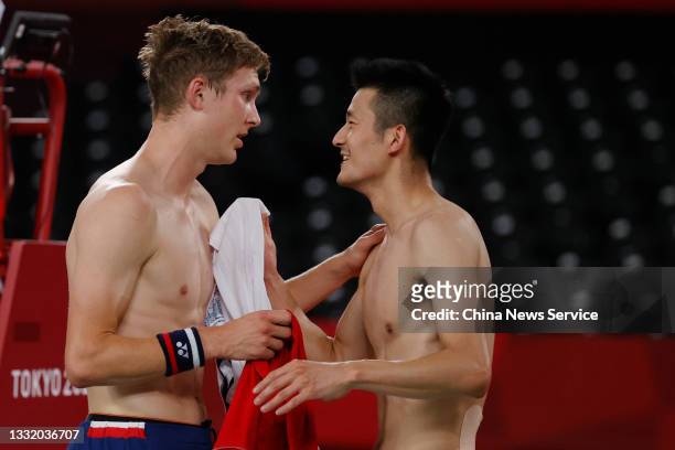 Gold medalist Victor Axelsen of Denmark and silver medalist Chen Long of China exchange their T-shirts after the Badminton Men's Singles Gold Medal...