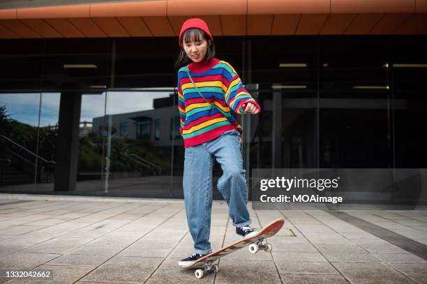 young asian girl riding skateboard - woman longboard stock-fotos und bilder