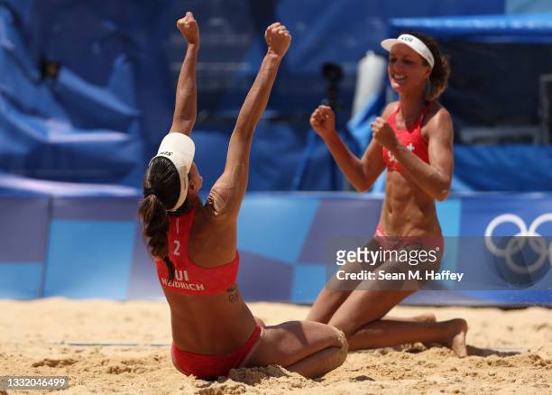 Joana Heidrich of Team Switzerland celebrates with Anouk Verge-Depre after defeating Team Brazil during the Women's Quarterfinal beach volleyball on...