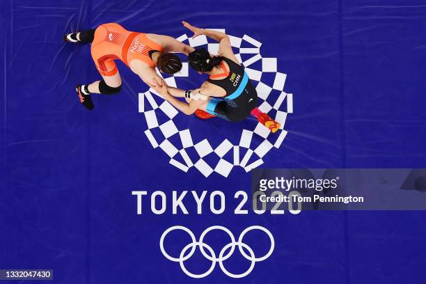Sara Dosho of Team Japan competes against Feng Zhou of team China during the Women's Freestyle 68kg Repechage on day eleven of the Tokyo 2020 Olympic...
