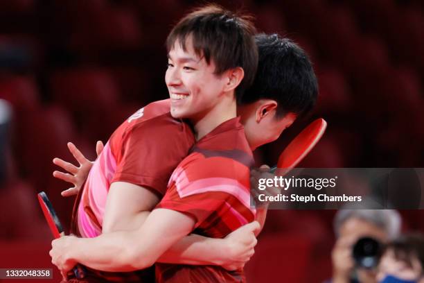 Harimoto Tomokazu and Koki Niwa of Team Japan embrace during their Men's Team Quarterfinals table tennis match on day eleven of the Tokyo 2020...