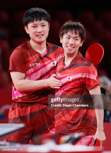 Harimoto Tomokazu and Koki Niwa of Team Japan react during their Men's Team Quarterfinals table tennis match on day eleven of the Tokyo 2020 Olympic...