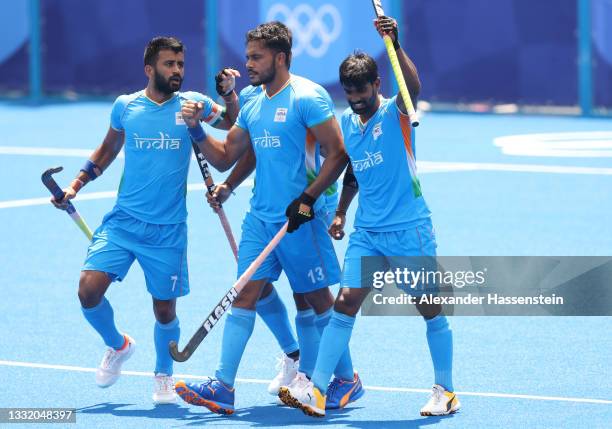 Harmanpreet Singh celebrates scoring the first goal with Sumit and Varun Kumar during the Men's Semifinal match between India and Belgium on day...