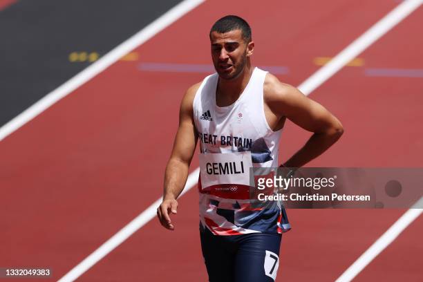 Adam Gemili of Team Great Britain reacts during round one of the Men's 200m heats after an apparent injury on day eleven of the Tokyo 2020 Olympic...