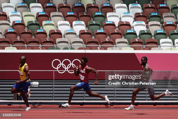 Sibusiso Matsenjwa of Team Swaziland, Noah Lyles of Team United States and Brendon Rodney of Team Canada compete in round one of the Men's 200m heats...