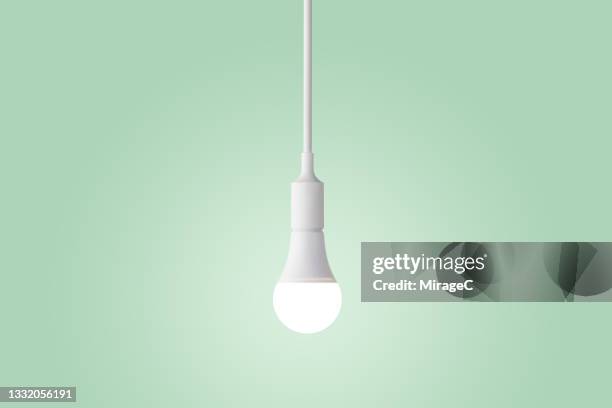 illuminated led light bulb glowing on green - 電燈 個照片及圖片檔