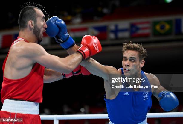Muslim Gadzhimagomedov of Team Russian Olympic Committee exchanges punches with David Nyika of Team New Zealand during the Men's Heavy semi final on...
