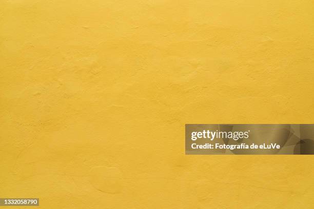 yellow wall texture surface background - yellow fotografías e imágenes de stock