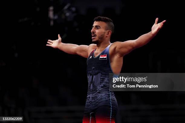 Mohamed Ibrahim Elsayed of Team Egypt celebrates defeating Karen Aslanyan of Team Armenia during the Men's Greco-Roman 67kg Quarter Final on day...