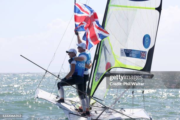 Dylan Fletcher and Stuart Bithell of Team Great Britain celebrate as they win gold in the Men's Skiff 49er class on day eleven of the Tokyo 2020...