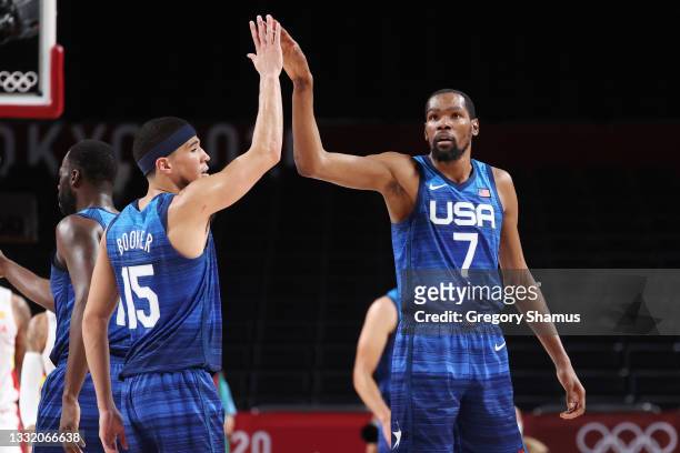 Kevin Durant and Devin Booker of Team United States celebrate a play against Spain during the first half of a Men's Basketball Quarterfinal game on...