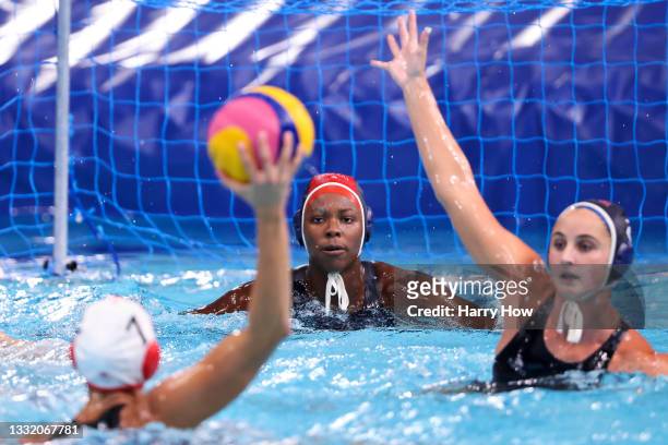 Ashleigh Johnson of Team United States prepares to save a shot from Joelle Bekhazi of Team Canada during the Women's Quarterfinal match between...