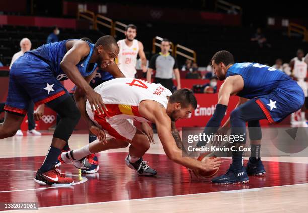 Willy Hernangomez of Team Spain dives for a loose ball against Khris Middleton and Zachary Lavine of Team United States during the second half of a...