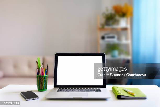 open laptop with white isolated background on a white desk - open laptop on desk stock-fotos und bilder