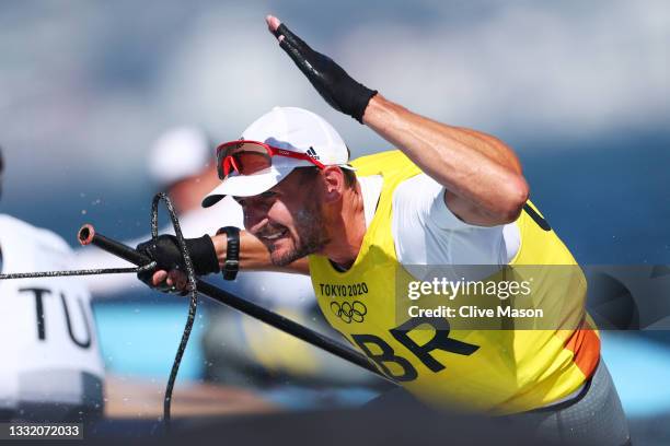 Giles Scott of Team Great Britain celebrates after winning gold in the Men's Finn class on day eleven of the Tokyo 2020 Olympic Games at Enoshima...