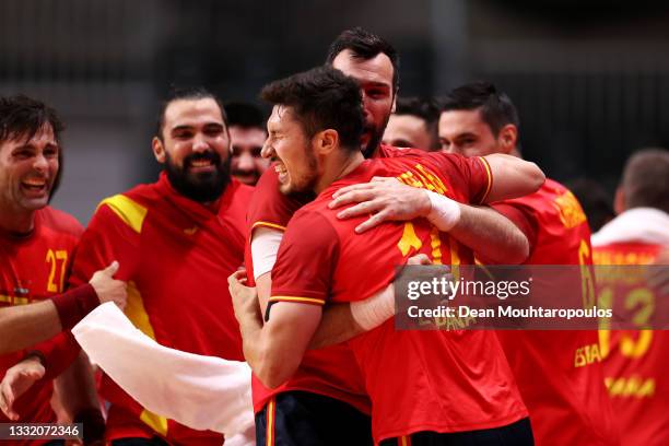 Alex Dujshebaev Dovichebaeva of Team Spain embraces teammate Gedeon Guardiola Villaplana after winning the Men's Quarterfinal handball match between...