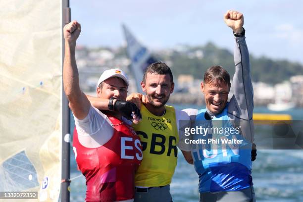 Giles Scott of Team Great Britain celebrates after winning gold alongside silver medalist Zsombor Berecz of Team Hungary and bronze medalist Joan...