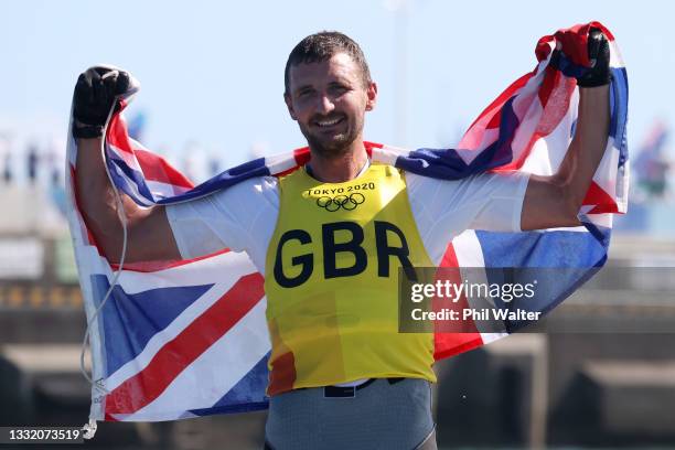 Giles Scott of Team Great Britain celebrates after winning gold in the Men's Finn class on day eleven of the Tokyo 2020 Olympic Games at Enoshima...