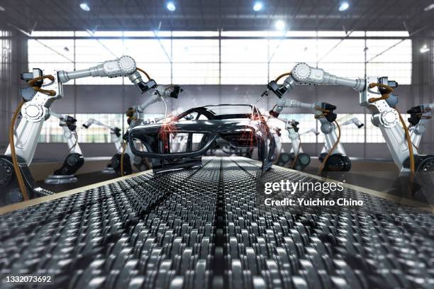 robotic arm in assembly automobile manufacturing plant - autofabrik stock-fotos und bilder