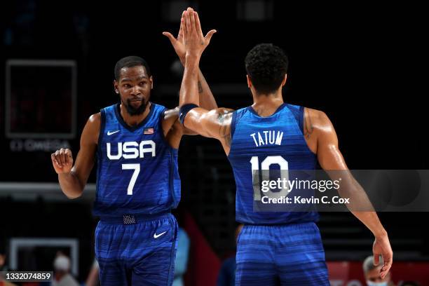Kevin Durant and Devin Booker of Team United States celebrate a win against Spain following a Men's Basketball Quarterfinal game on day eleven of the...
