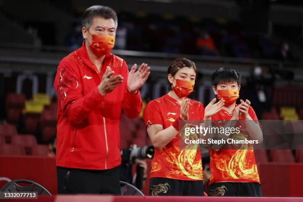 Chen Meng and Sun Yingsha of Team China applaud on the sidelines during their Women's Team Quarterfinal table tennis matchon day eleven of the Tokyo...