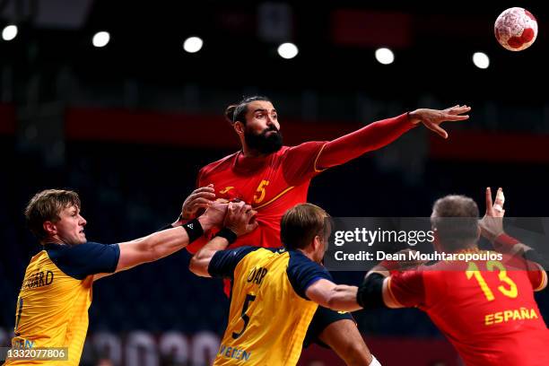 Jorge Maqueda Peno of Team Spain passes the ball while under pressure from Jonathan Carlsbogard and Max Darj of Team Sweden during the Men's...