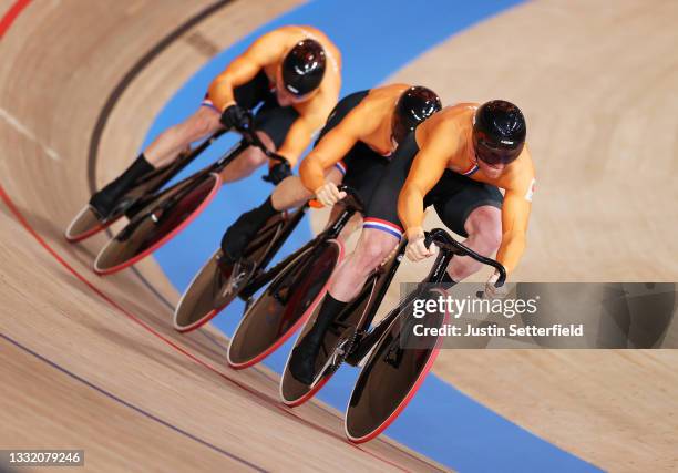 Roy van den Berg of Team Netherlands and teammates sprint to setting a new Olympic record ahead of Team Australia during the Men´s team sprint...