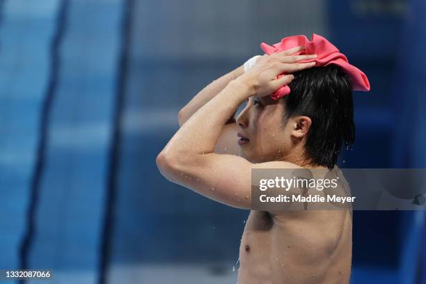 Woo Ha-ram of Team South Korea towels down in the Men's 3m Springboard Final on day eleven of the Tokyo 2020 Olympic Games at Tokyo Aquatics Centre...