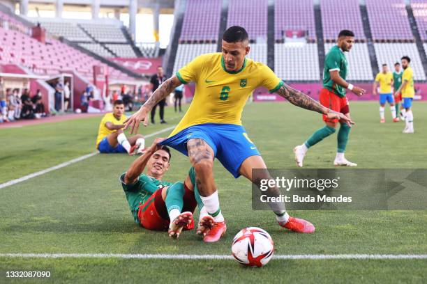 Guilherme Arana of Team Brazil is challenged by Uriel Antuna of Team Mexico during the Men's Football Semi-final match between Mexico and Brazil on...