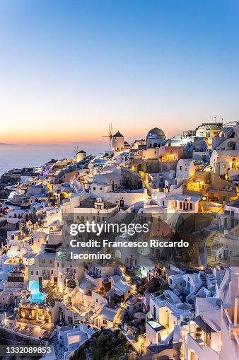 Oia, Santorini Island, Cyclades, Greece. Cityscape, Houses and churches at sunset Oia, Santorini Island, Cyclades, Greece. Cityscape, Houses and churches at sunset