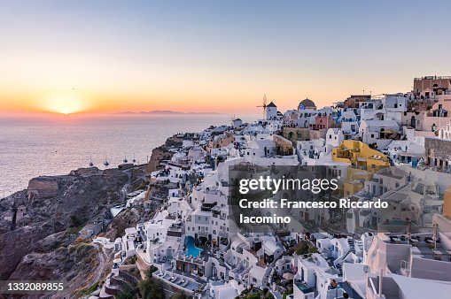 Oia, Santorini Island, Cyclades, Greece. Cityscape, Houses and churches at sunset Oia, Santorini Island, Cyclades, Greece. Cityscape, Houses and churches at sunset