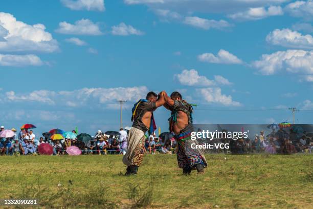 Wrestlers compete during the annual Naadam festival at Sonid Right Banner on July 30, 2021 in Xilingol League, Inner Mongolia Autonomous Region of...