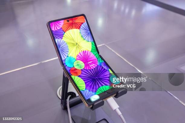 Foldable organic light-emitting diode screen is on display at the TCL booth during the Universal Digaital-Life Expo 2021 at Shanghai New...