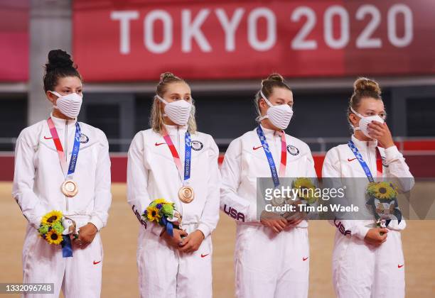 Bronze medalists Chloe Dygert, Megan Jastrab, Jennifer Valente, Emma White of Team United States, pose on the podium during the medal ceremony during...