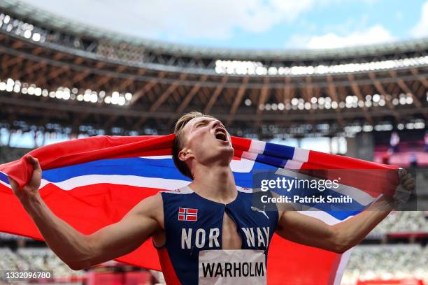 Karsten Warholm of Team Norway celebrates winning the gold medal in the Men's 400m Hurdles Final on day eleven of the Tokyo 2020 Olympic Games at...