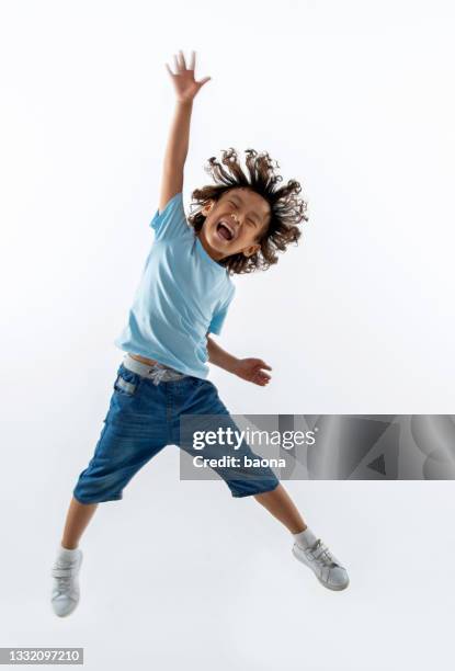 little boy jumping on white background - kids playing imagens e fotografias de stock