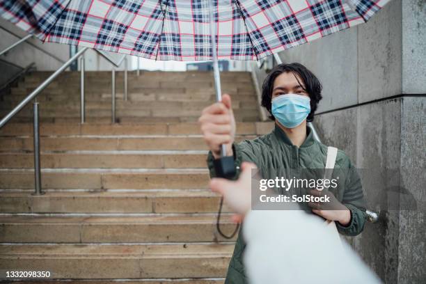 here you go! - sharing umbrella stock pictures, royalty-free photos & images