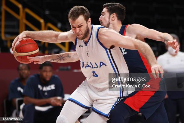 Nando de Colo of Team France knocks the ball away from Nicolo Melli of Team Italy during the second half of a Men's Basketball Quarterfinal game on...