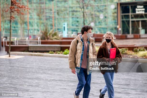 meeting up on campus - british culture walking stock pictures, royalty-free photos & images