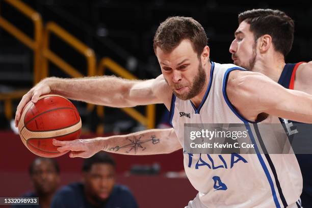 Nando de Colo of Team France knocks the ball away from Nicolo Melli of Team Italy during the second half of a Men's Basketball Quarterfinal game on...