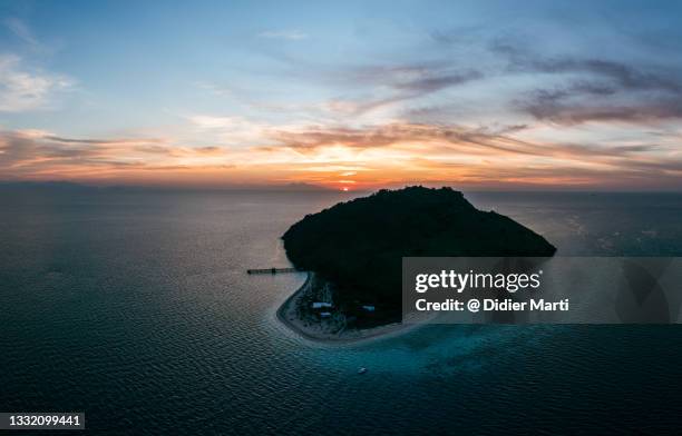 stunning sunset over the sebolon island in indonesia - flores indonesia stock pictures, royalty-free photos & images