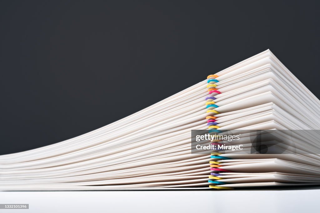 Stacked Paper Files With Colorful Paper Clips
