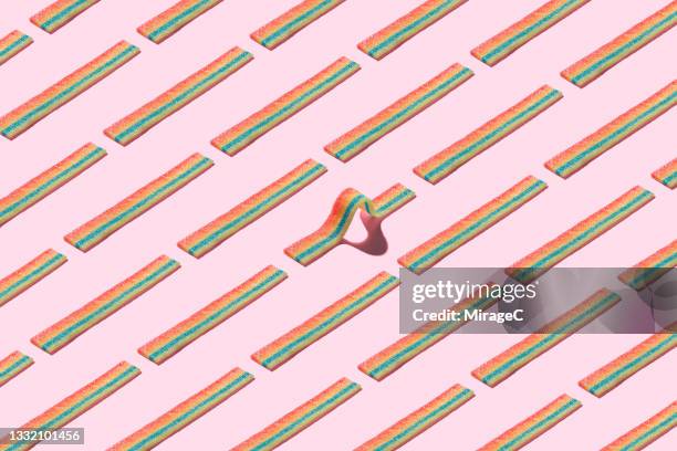 curved striped candy standing out form the crowd - sour taste stock pictures, royalty-free photos & images