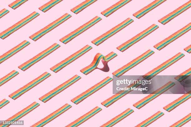 curved striped candy standing out form the crowd - sour taste bildbanksfoton och bilder