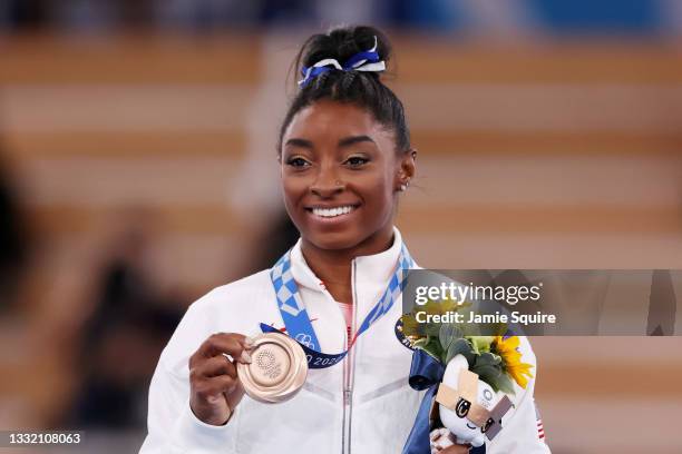 Simone Biles of Team United States poses with the bronze medal during the Women's Balance Beam Final medal ceremony on day eleven of the Tokyo 2020...