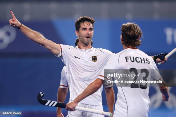 Lukas Windfeder of Team Germany celebrates with teammate Florian Fuchs after scoring their team's first goal during the Men's Semifinal match between...